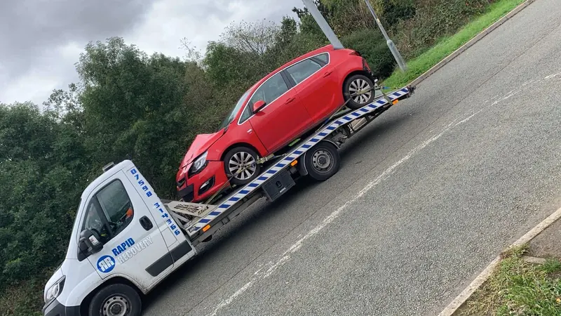 Rapid Recovery truck carrying a vehicle near Corby